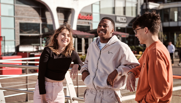 Students chatting outside restaurants