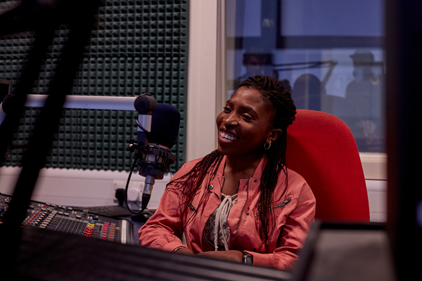 A woman sat in a radio studio