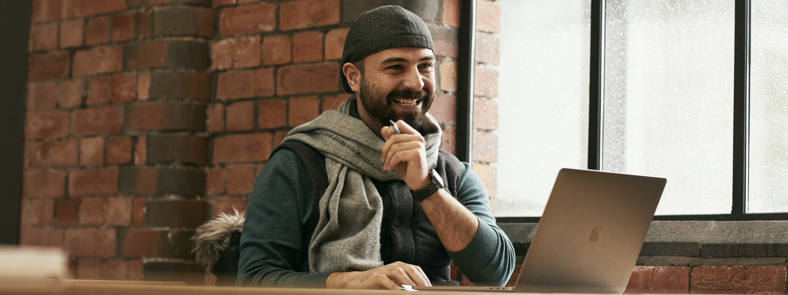 A man smiling at a computer