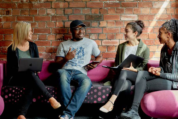 Student sat talking on sofa