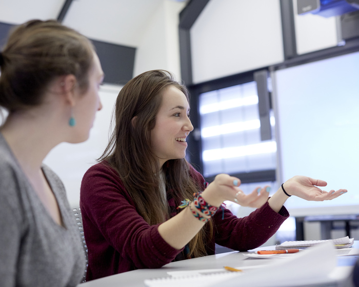 Two students talking to someone