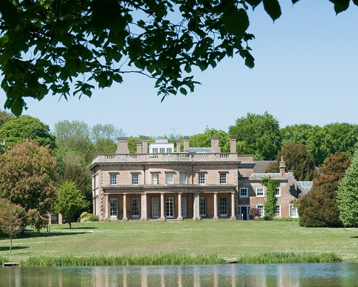 An old building with a lake in front of it