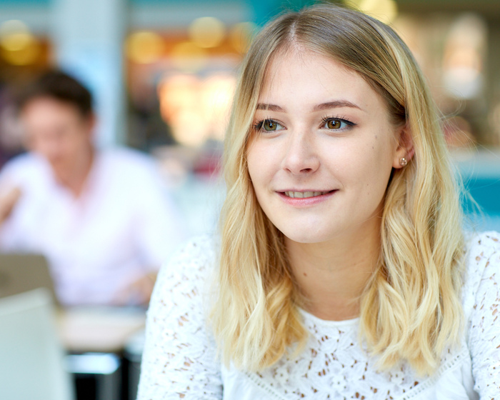 Female student sitting and smiling.