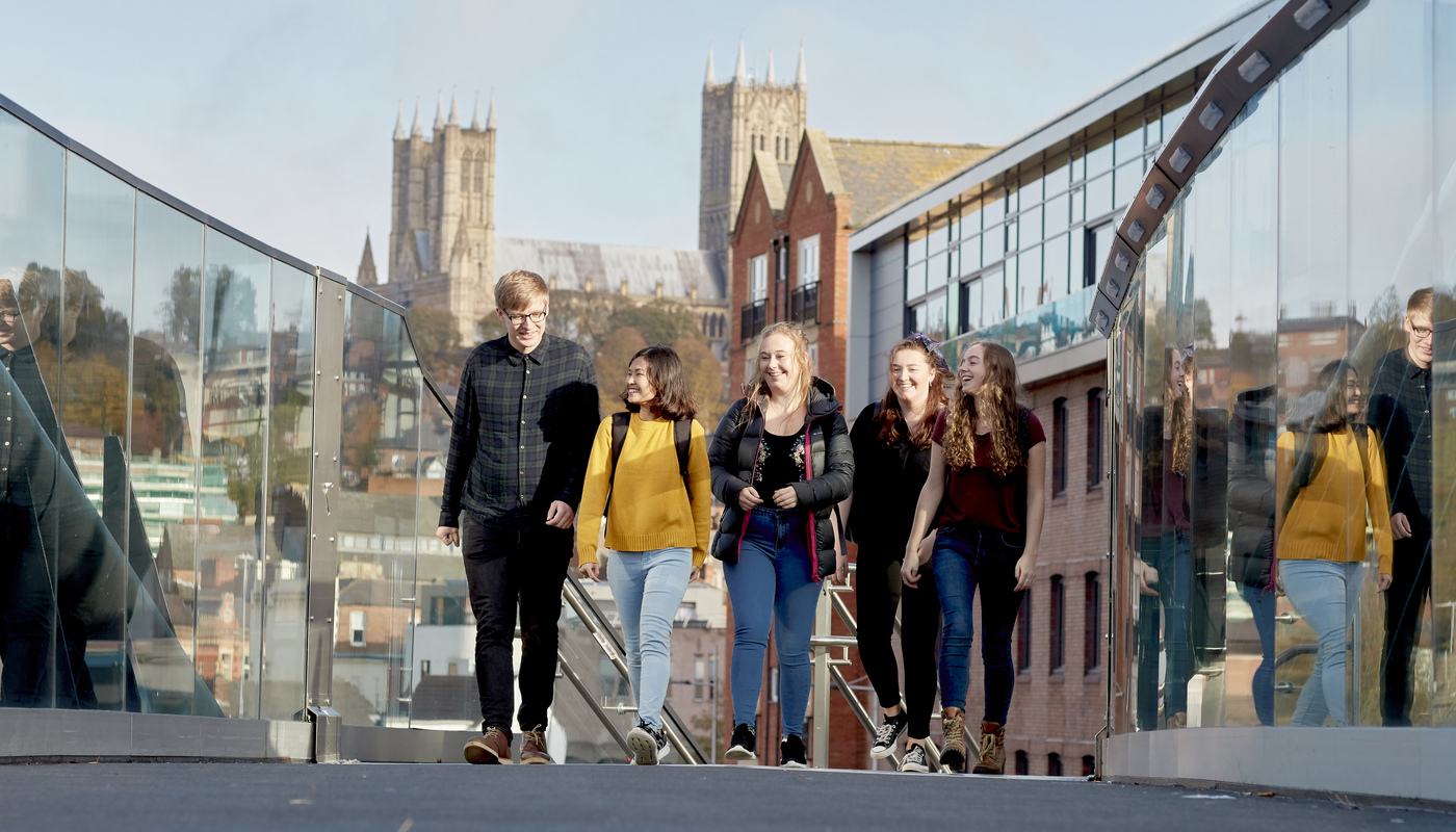 Students walking across a bridge