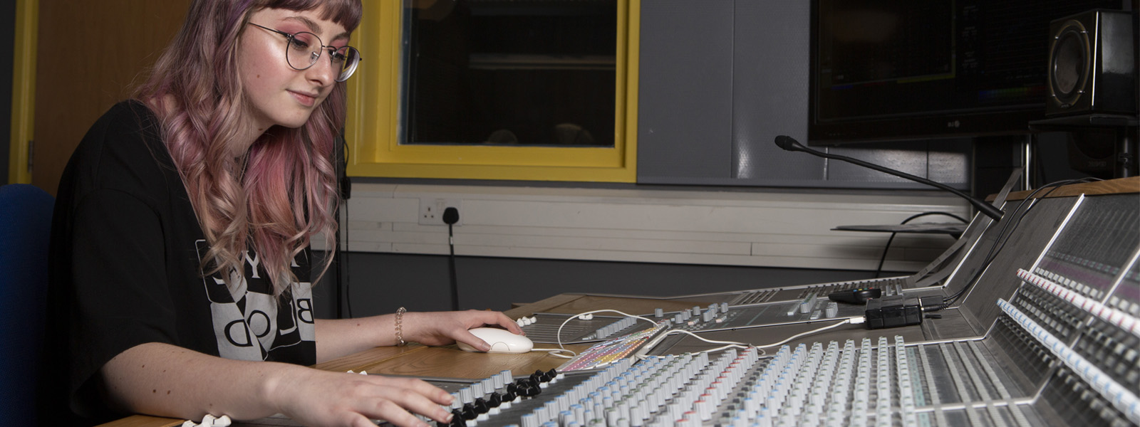 A student working at a mixing desk