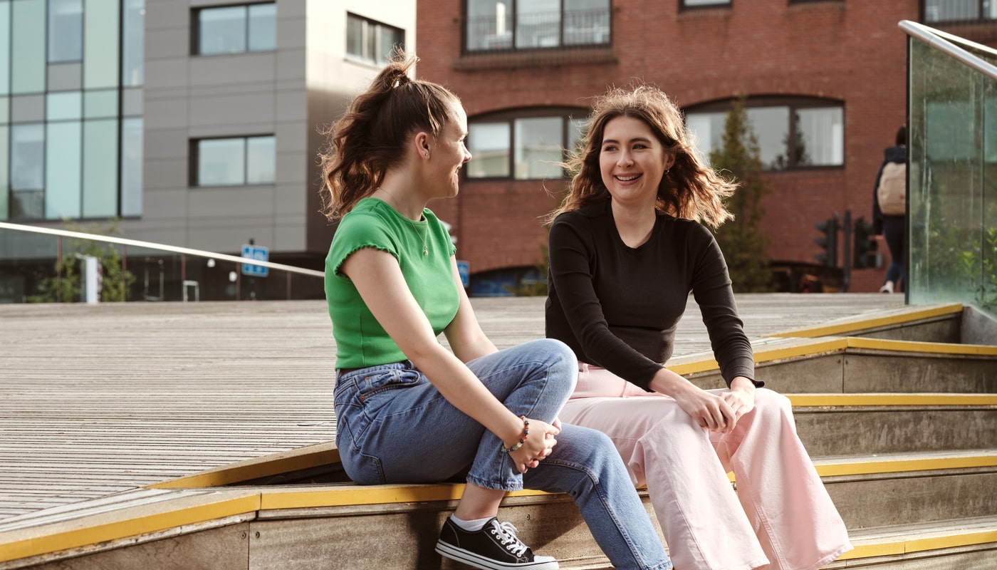 Students on steps chatting to each other