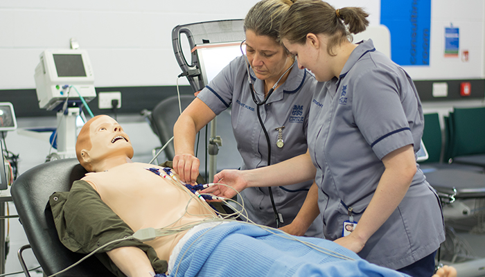 Trainee nursing associates taking part in a patient simulation experience.