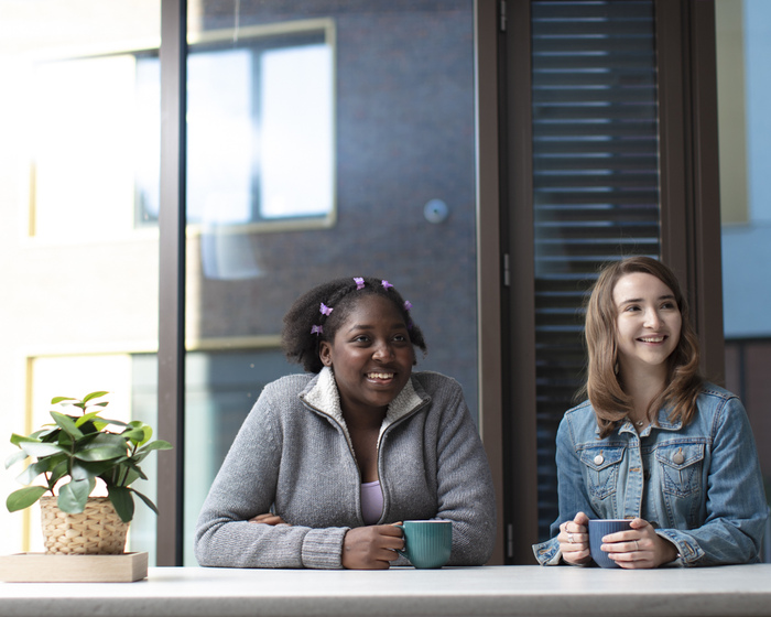 Students sitting in University accommodation.