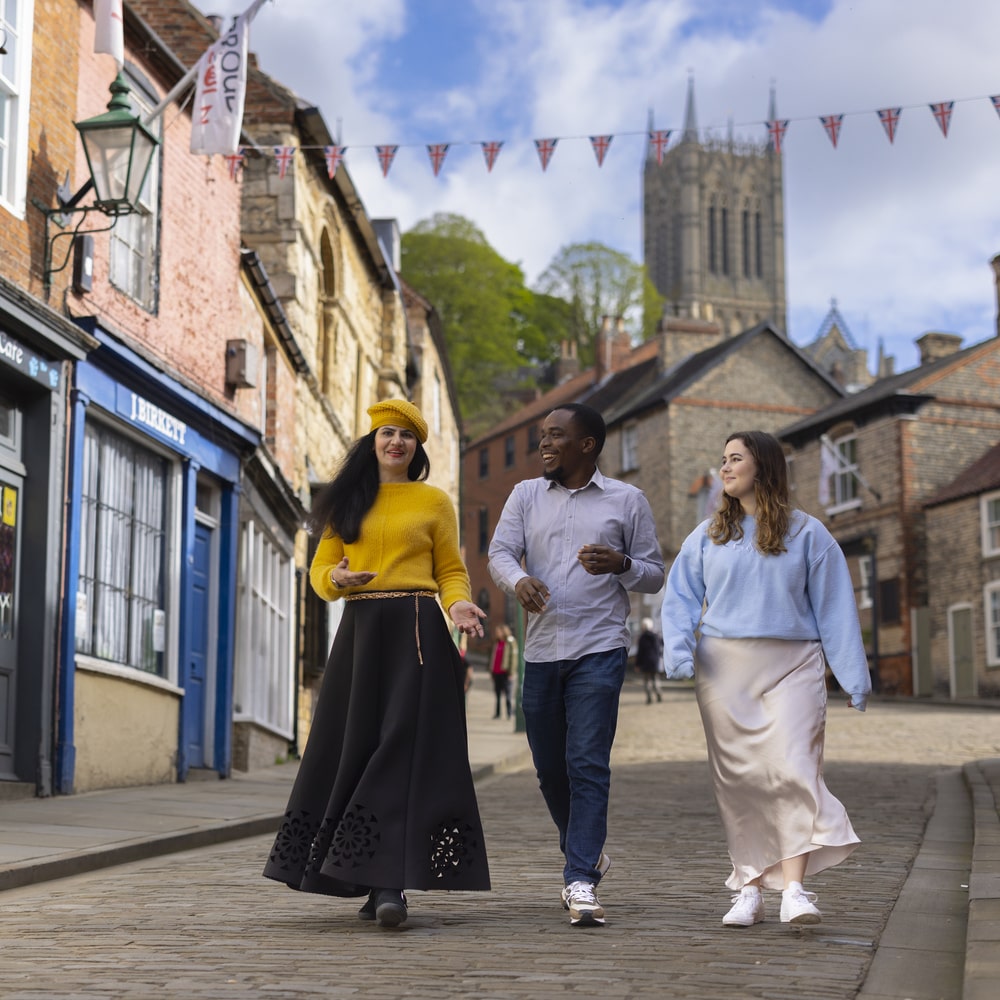 Students walking together down a cobbled street