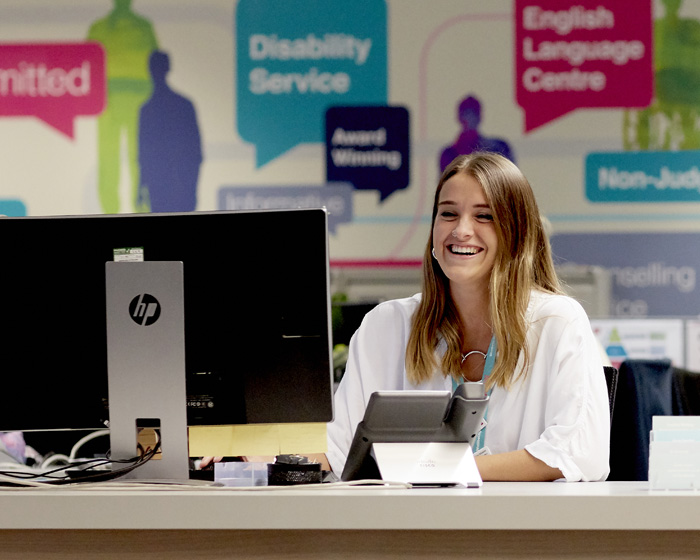 A member of staff working on the support centre reception