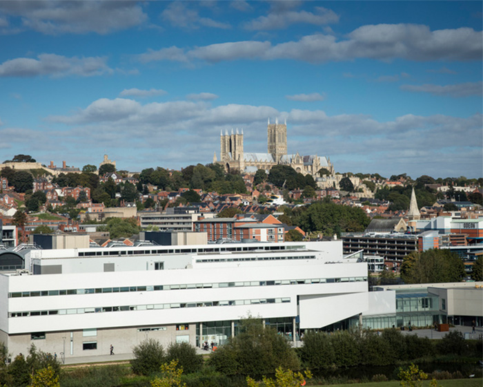 The city of Lincoln with the cathedral in the distance and a modern white building in the foreground