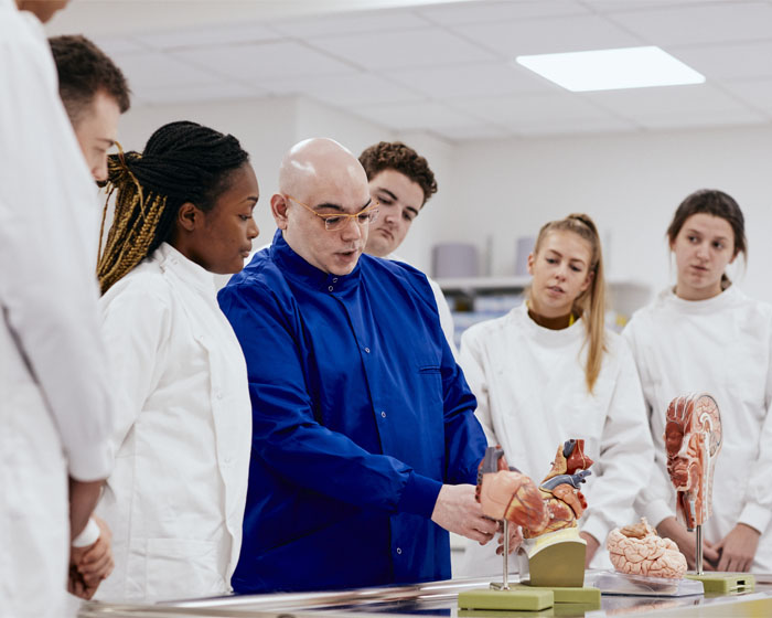 An academic giving a demonstration to a group of students in the medical centre