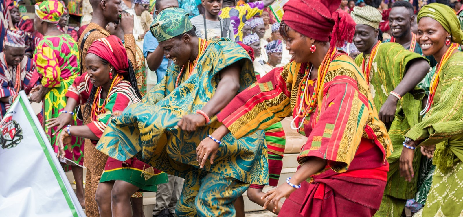 Nigerian cultural troupe dancing in traditional dress