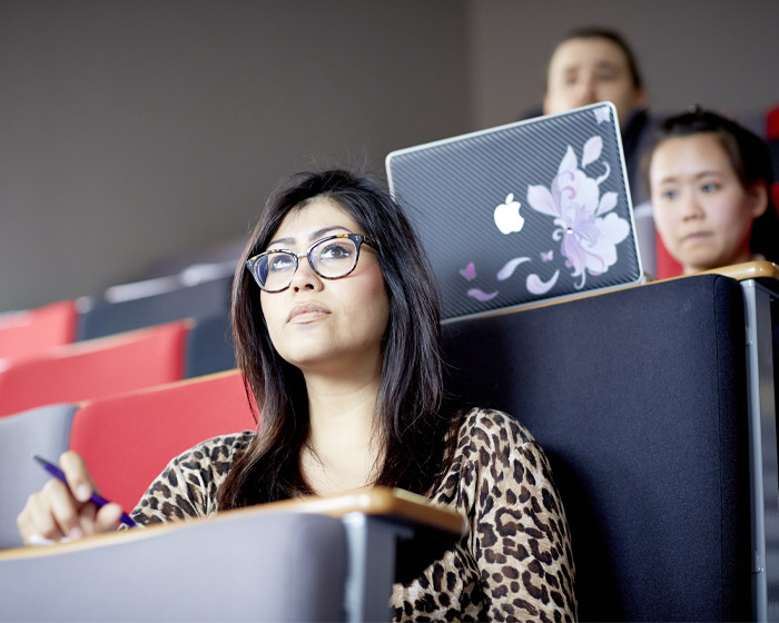 A group of students listening in a lecture theatre