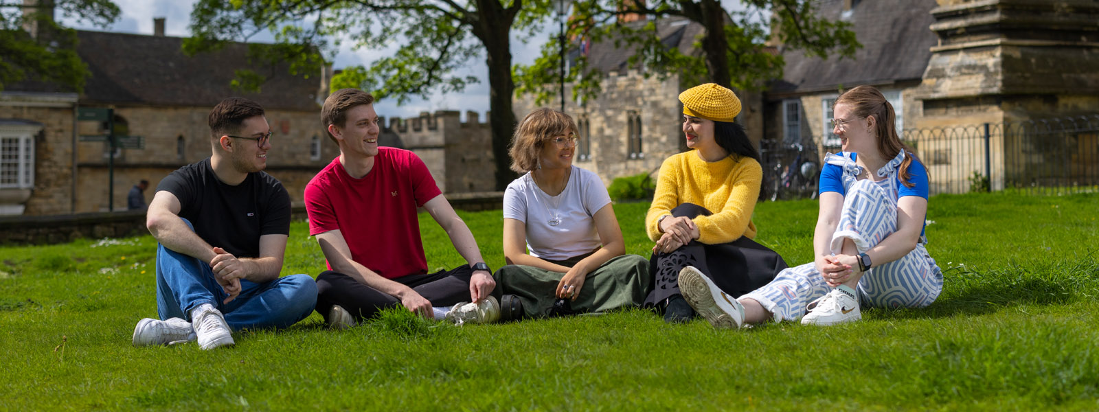 A group of students sitting on the grass