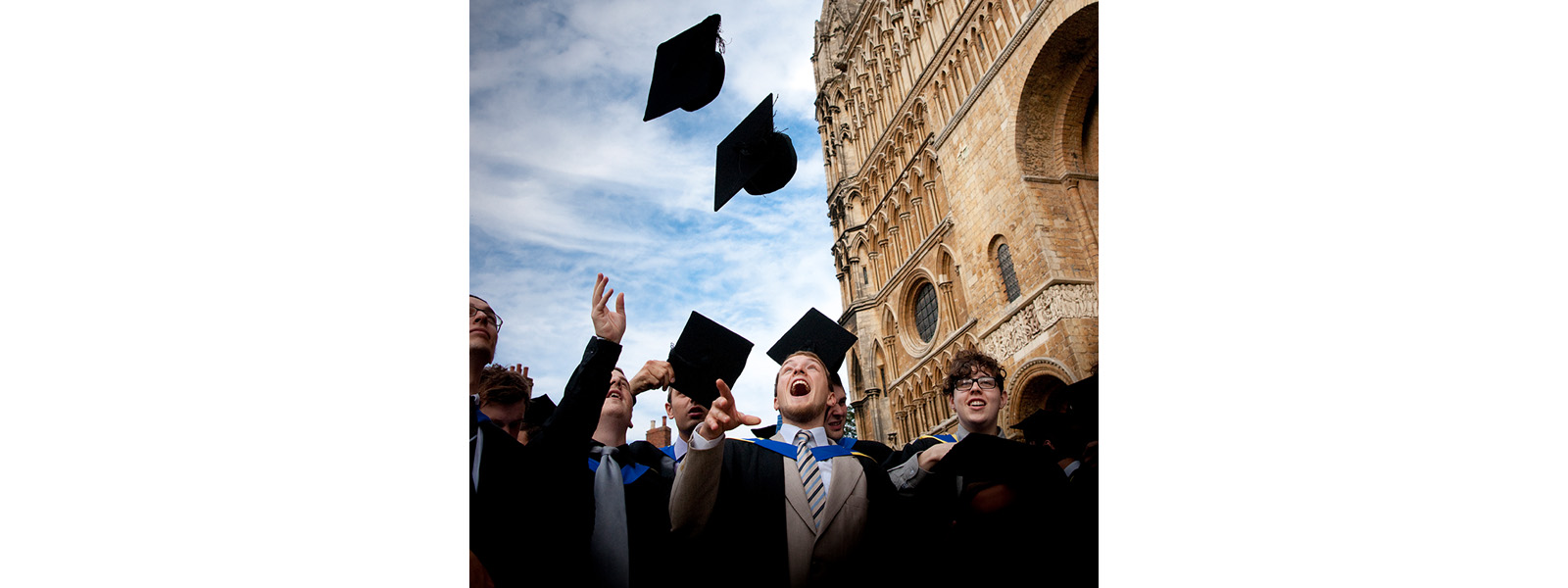 Students throwing their graduation hats into the air