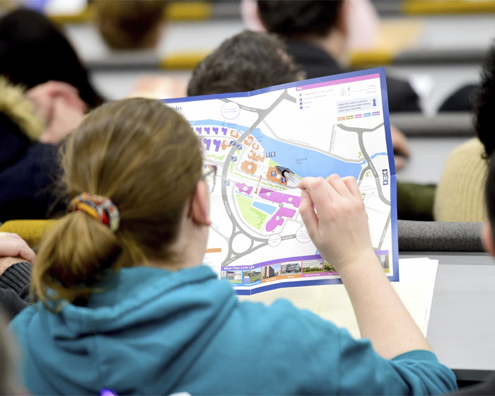 A visitor examines a campus map during an Open Day