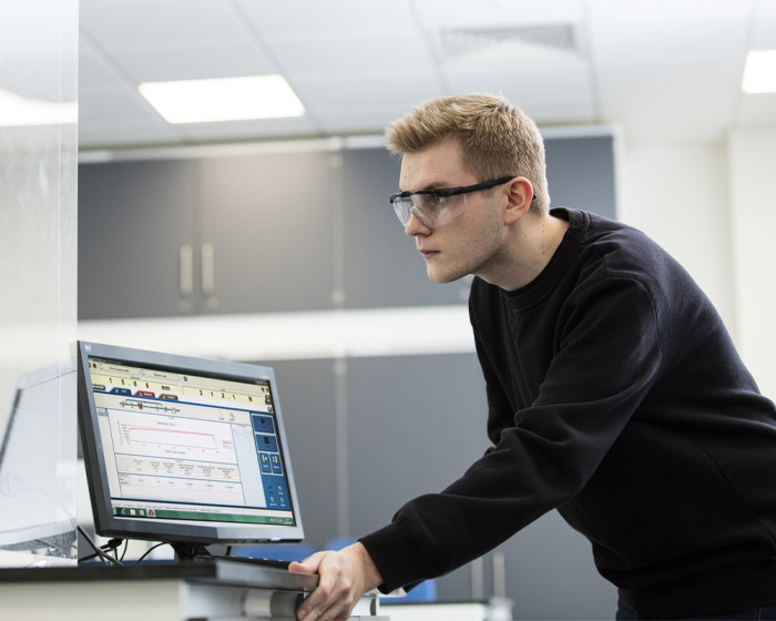 A student working on a computer in an engineering lab