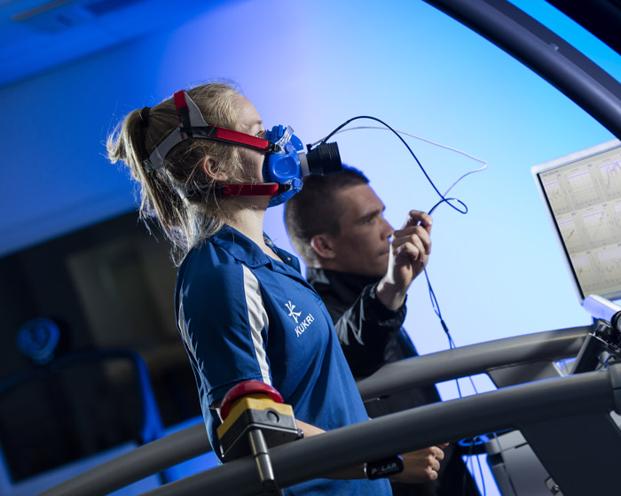 Students taking part in a physical training exercise on a running machine