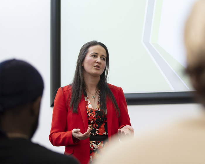 A lecturer talking to a group of students