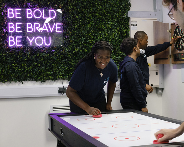 Residence Life team members playing air hockey