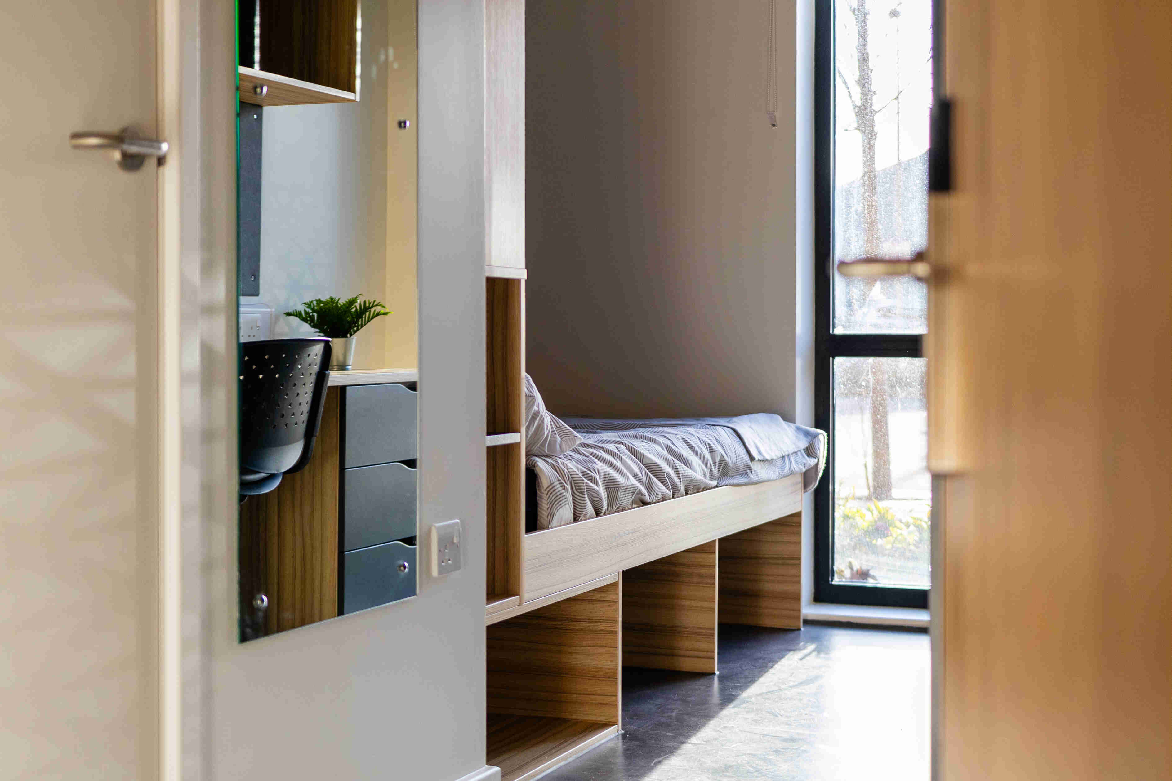 A bed, mirror and storage area