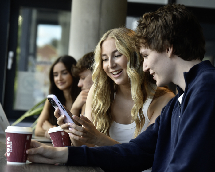 Two students chatting while in a cafe