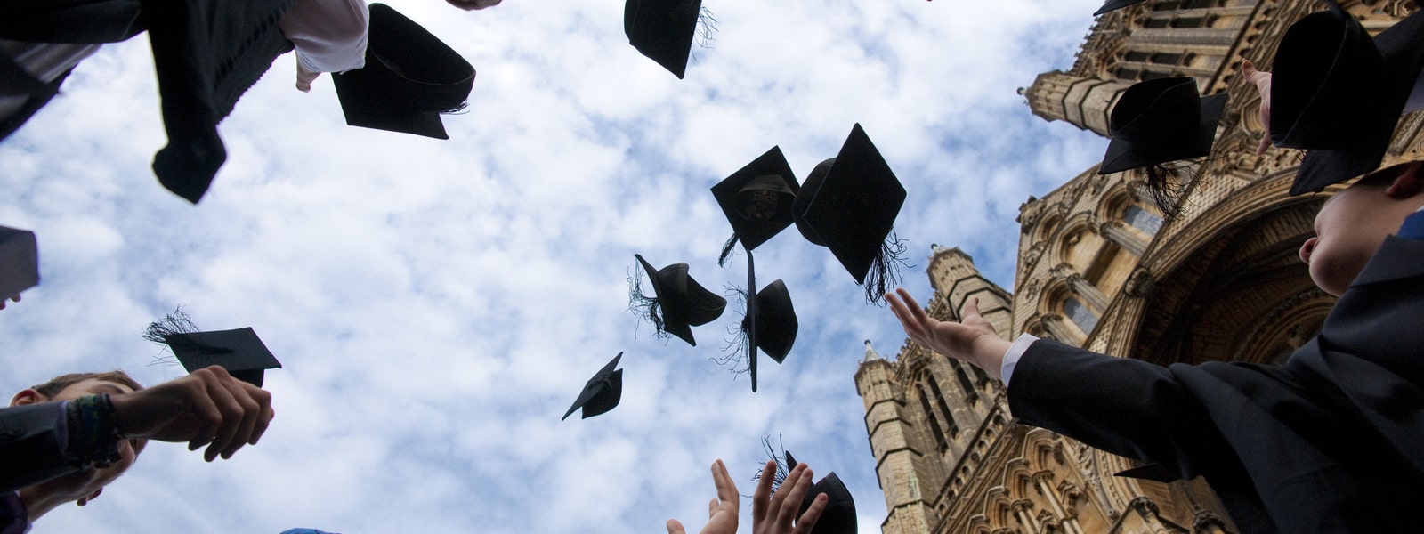 Graduates throwing graduation caps at the Cathedral