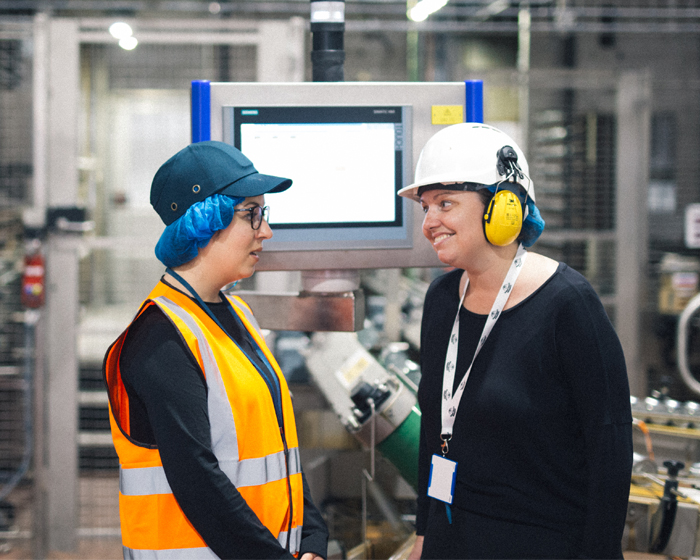 Staff talking in a factory space