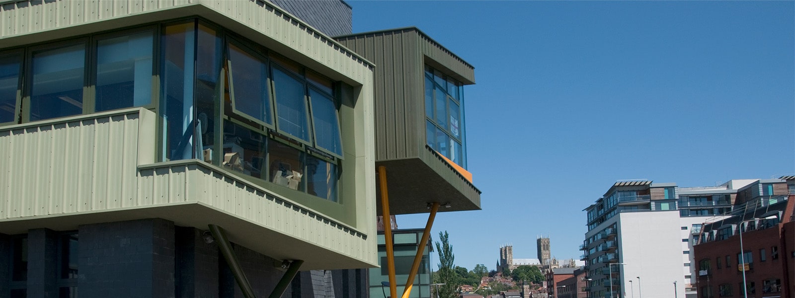 A grey building with offices in boxes on the side