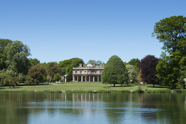 A view of the Riseholme Park Campus across a lake