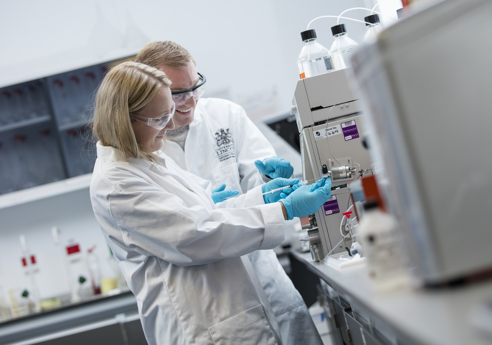 Student and staff member working together in a laboratory