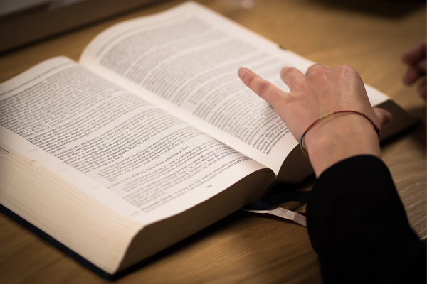 A hand resting on a book