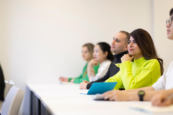 Students sat at a table smiling