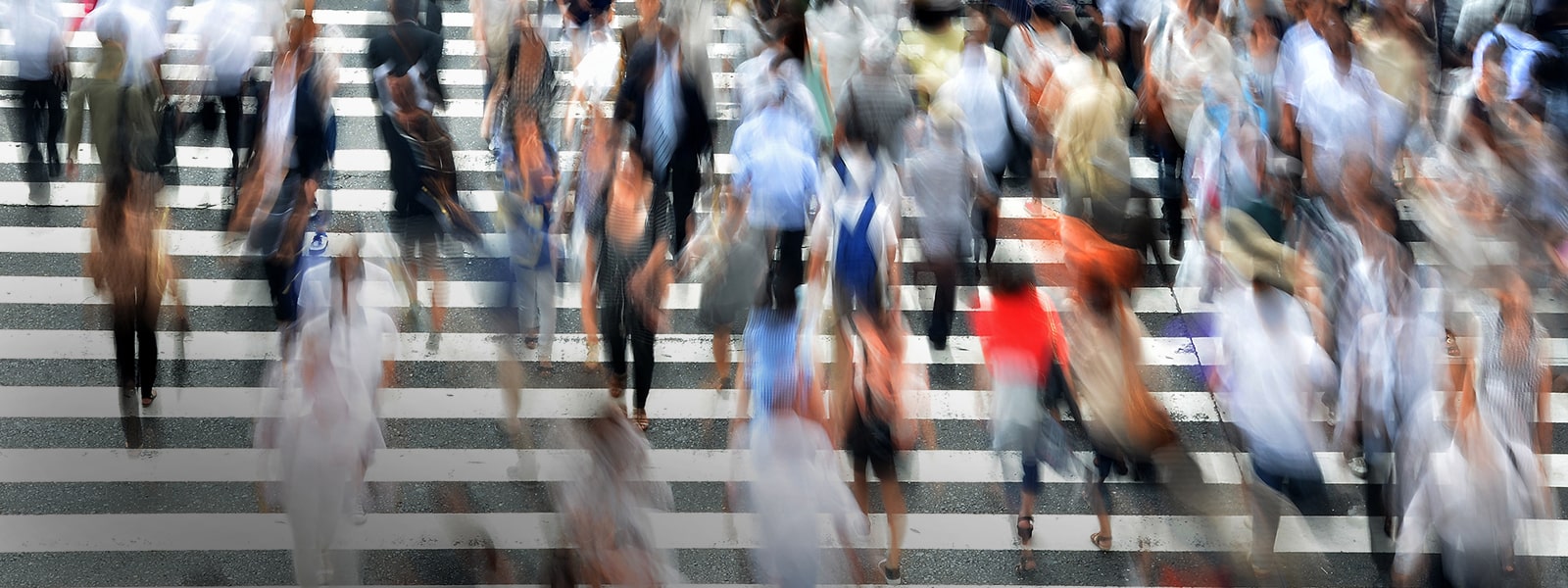 Blurred people using road crossing