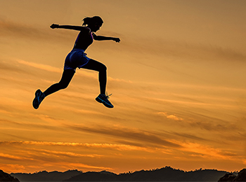 Athletic woman jumping in the air.