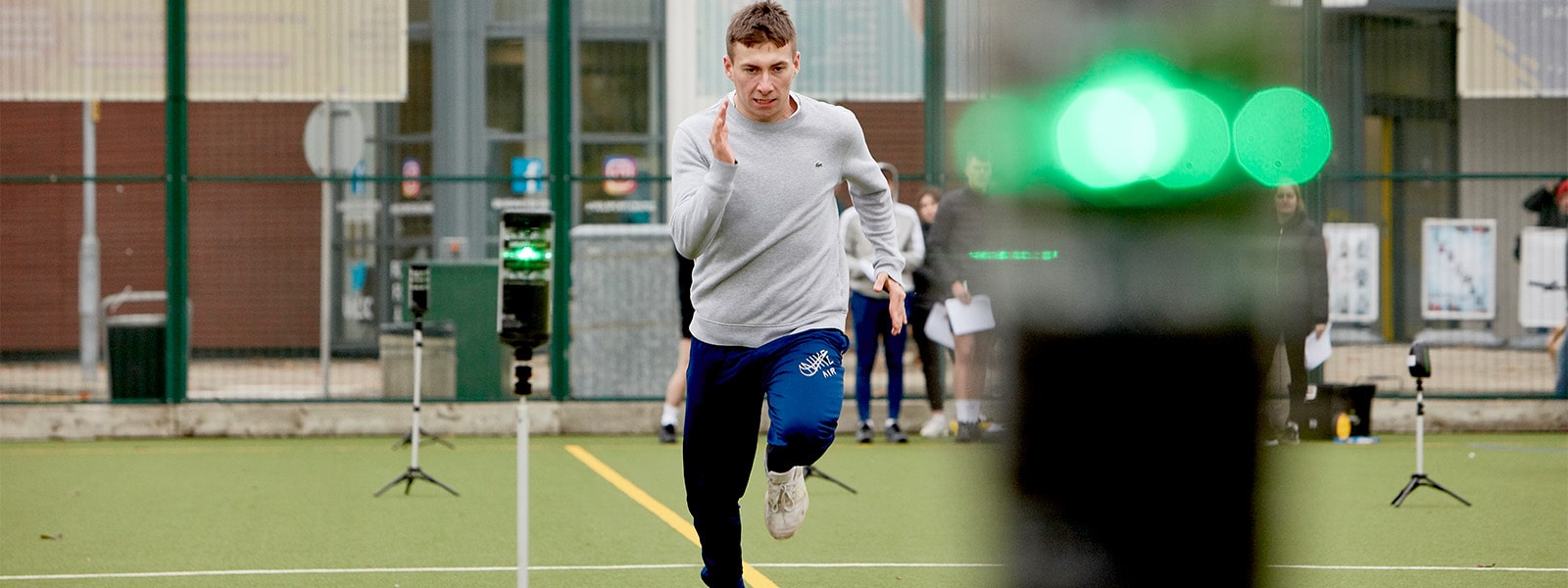 Student running on Astroturf