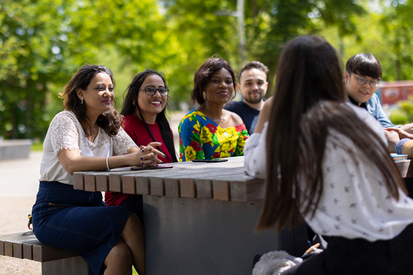 Students sat at a table smiling