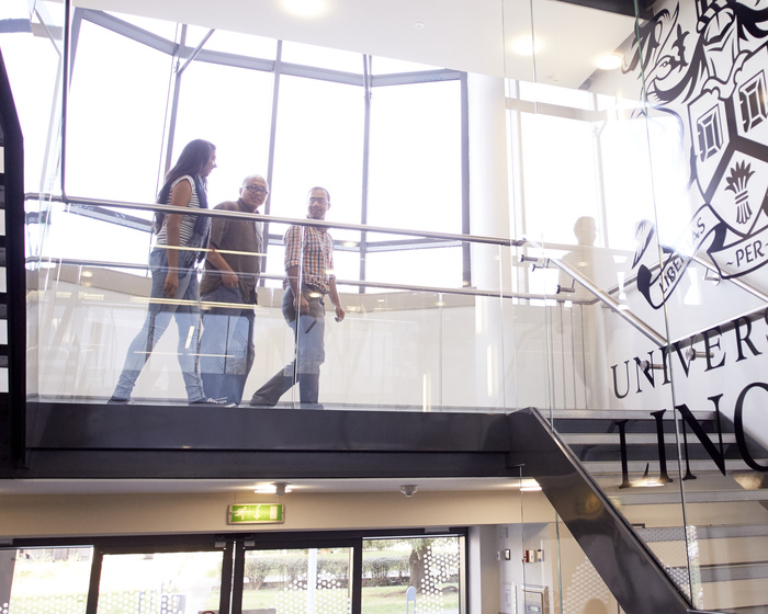 Staff chatting while walking down stairs