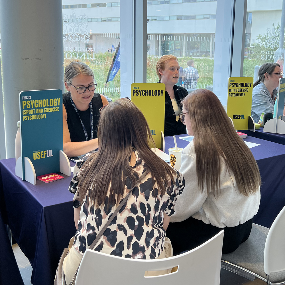 Students chatting to an academic at an Open Day