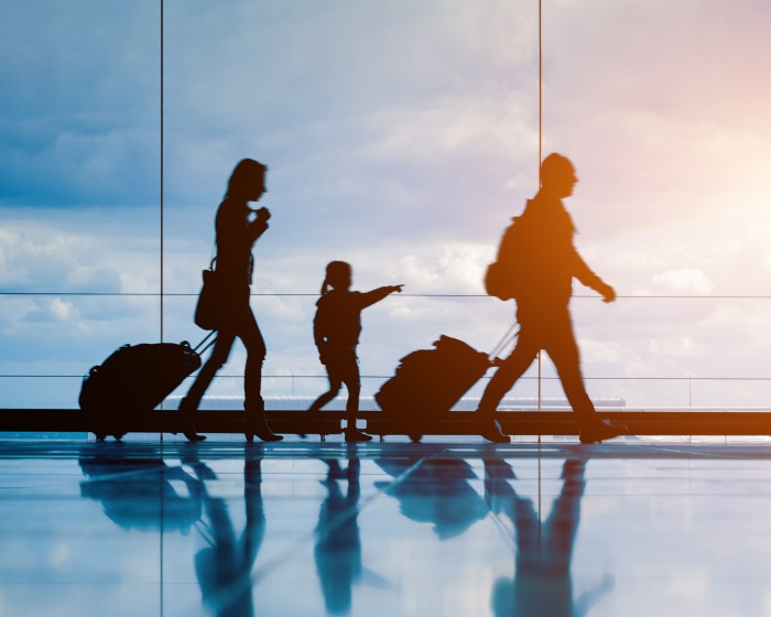 A family moving luggage at an airport