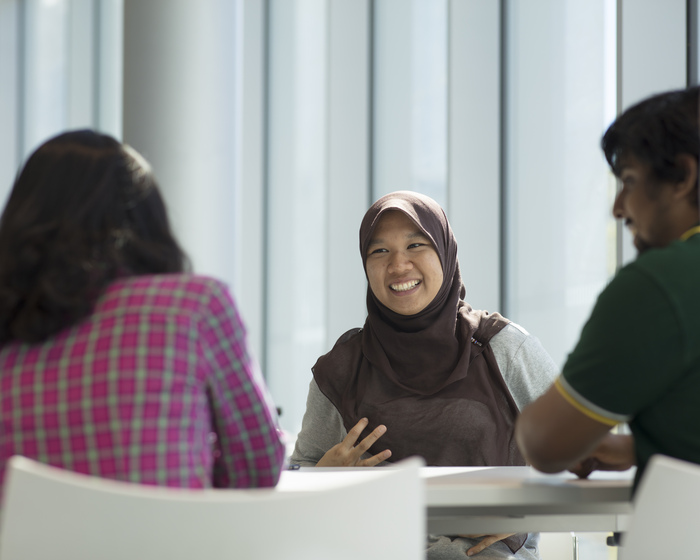 Students chatting in the Isaac Newton Building