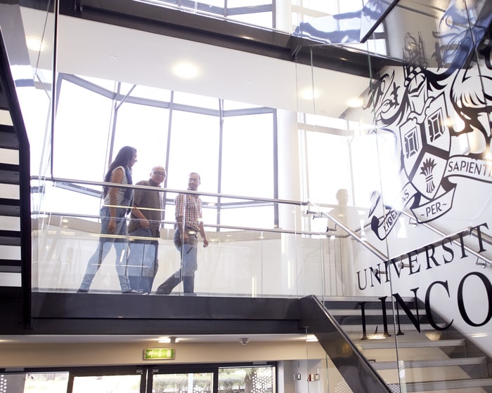 Staff walking down the stairs in the Joseph Banks Laboratories