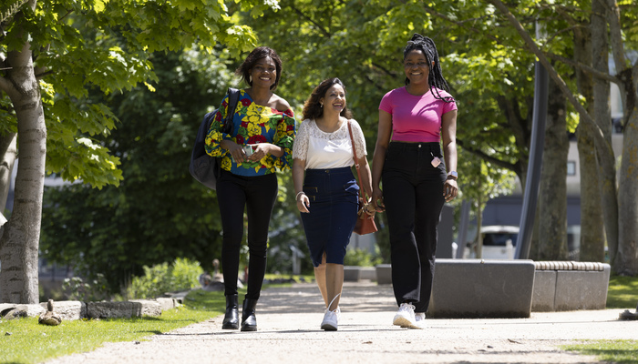 Students walking alongside the Brayford in summer