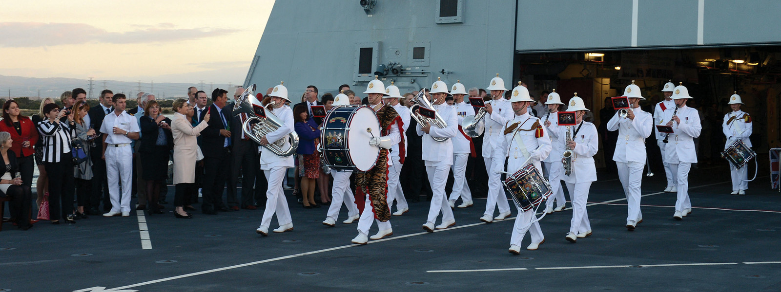A naval band performing on the deck of a ship