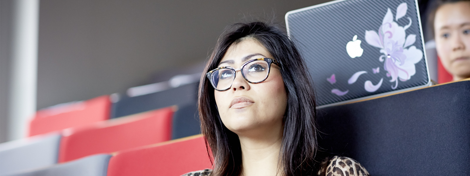 Student listening in university lecture theatre