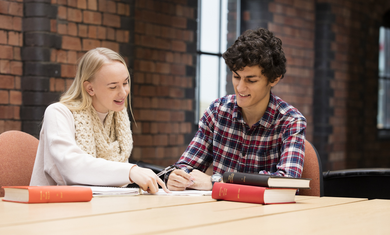 Male student and female student working together in the University's Great Central Warehouse Library. 