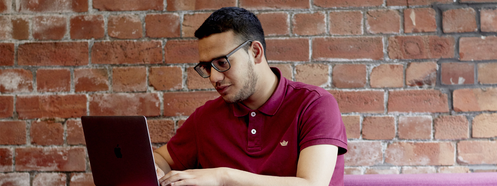 Male student working on a tablet in the library