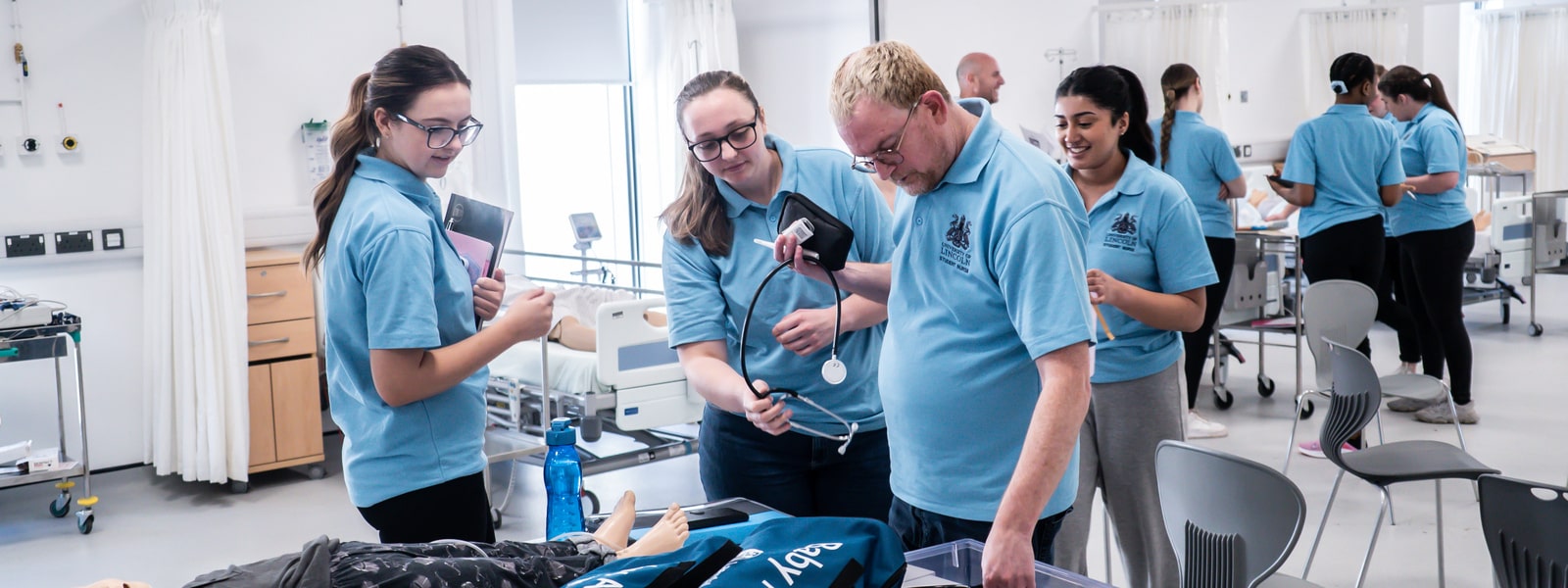 Students nurses taking part in simulated scenarios