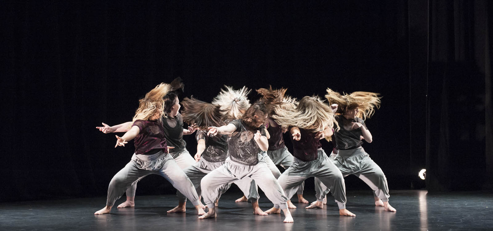 Group of students on stage during a dance performance 